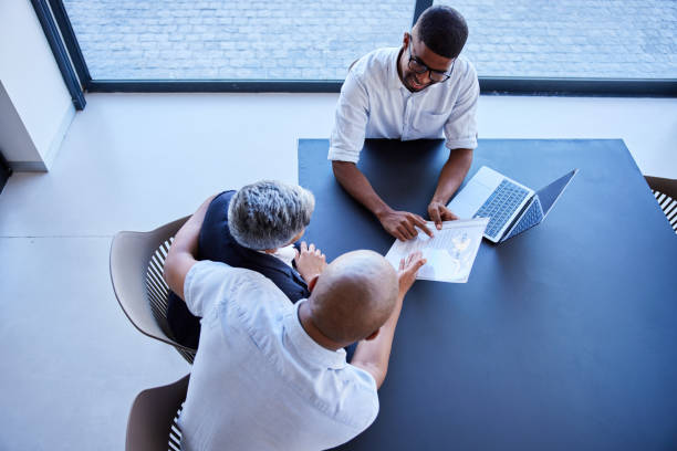 istock Financial advisor discussing documents with a mature couple in his office 1398300110