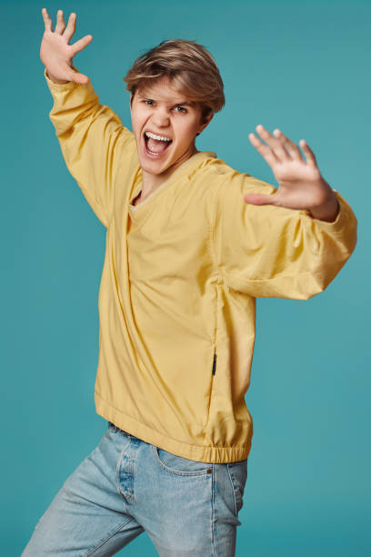 istock young man in casual yellow clothes dancing 1398301216