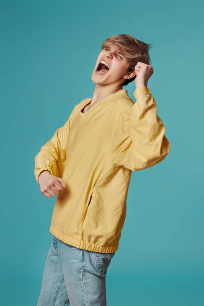 istock young man in casual yellow clothes dancing 1398301218