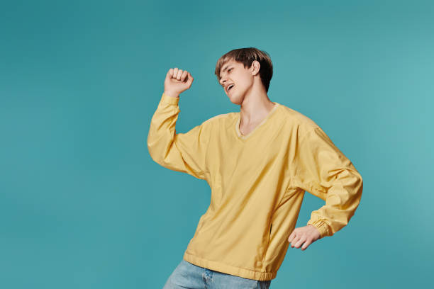 istock young man in casual yellow clothes dancing 1398301237