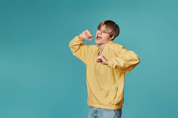 istock young man in casual yellow clothes dancing 1398301238