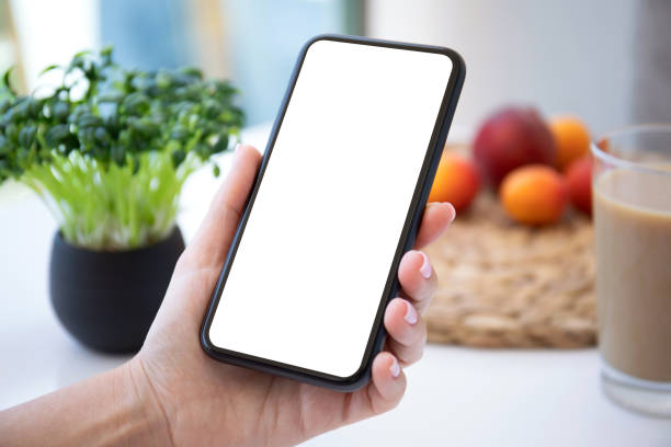 istock female hand holding phone with isolated screen in cafe 1398302343