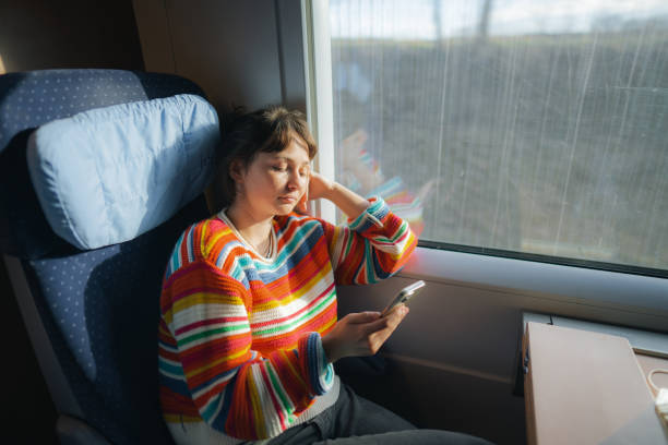 istock Womanising smartphone while  traveling in the train 1398303726