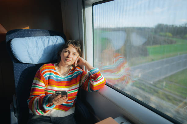 istock Womanising smartphone while  traveling in the train 1398303727
