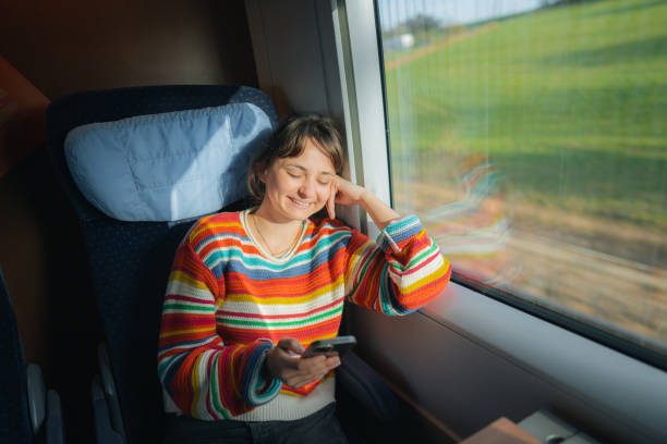 istock Womanising smartphone while  traveling in the train 1398303889
