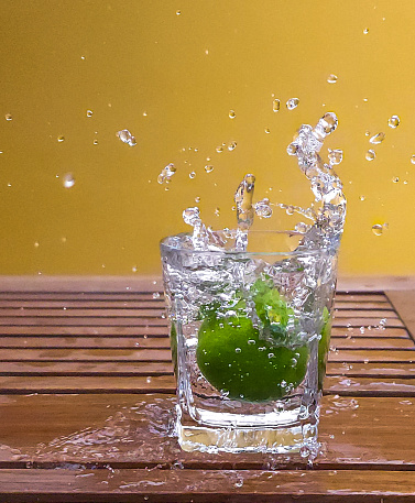 Cross section view on slices of lemon and lime in sparkling water. Homemade lemonade, source of vitamins, healthy lifestyle concept.