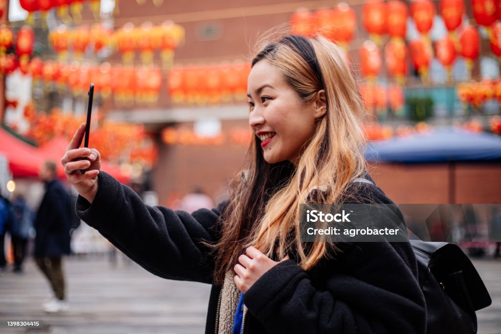 Young Asian Woman using phone at Chinatown Chinatown Stock Photo