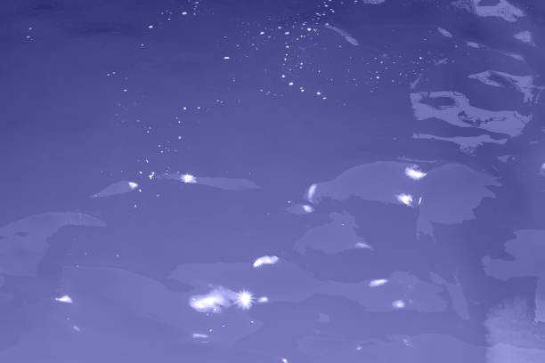istock blue water wave texture background. Rippled water. Shiny purple and blue water surface. 1398305949