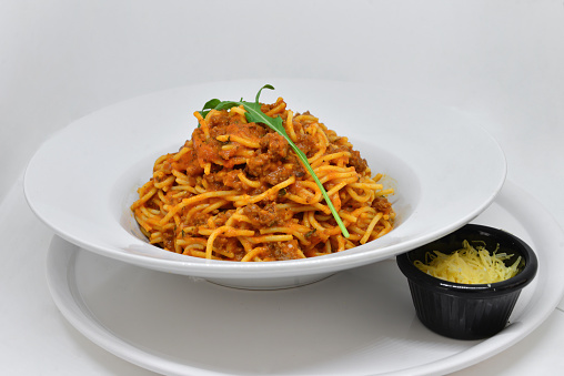 Spaghetti in a dish on a white background