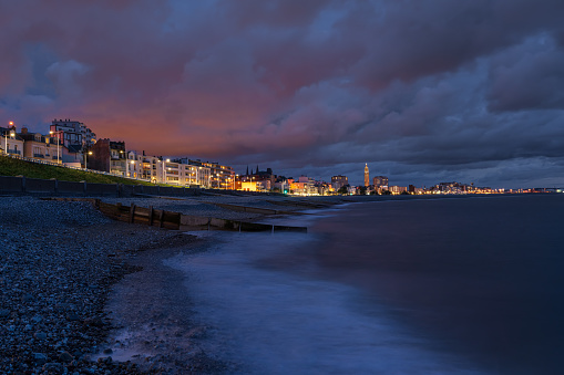 Sunset at the coastline of Le Havre in Normandy, France. Church of St. Joseph is seen the background