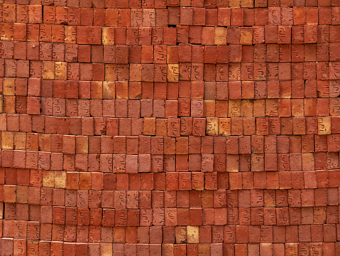 The brick wall is faced with red bricks. Background and texture. Copy space.