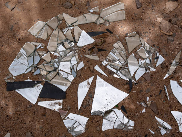 istock Shards of a broken mirror are scattered on the ground. Environmental pollution. 1398308279