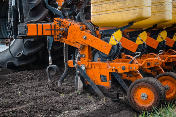 istock A tractor with a seed drill is engaged in planting corn. Close-up of the seed drill. Field work. 1398308560