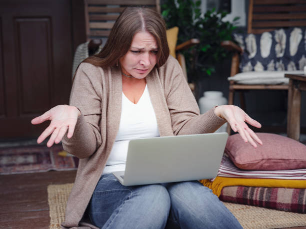 Stressed forgetful middle aged woman at home stock photo
