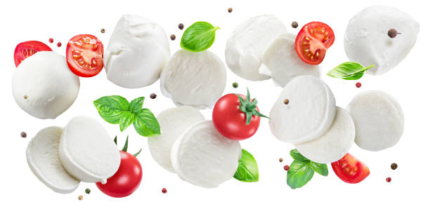 istock Flying slices of mozzarella cheese with cherry tomatoes, pepper and basil isolated on white background. The concept of organic products for Mediterranean cuisine caprese salad. 1398310942