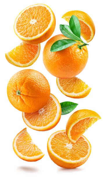 Ripe oranges with halves and slices with orange tree leaves randomly fall or levitate on a white background. Juicy background for your project. Clipping path. stock photo