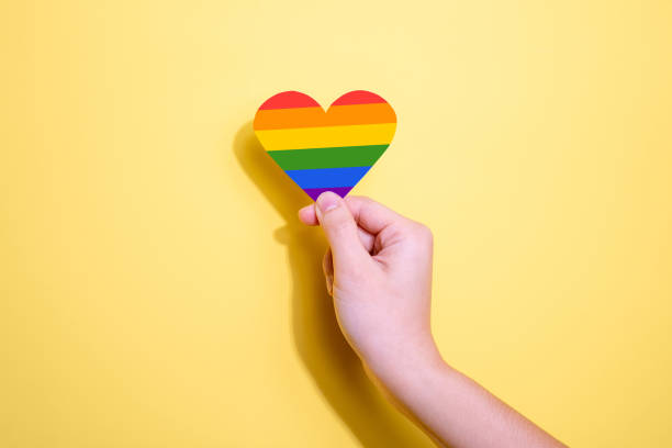istock Rainbow heart-shaped LGBTQ symbol on a yellow background. 1398312978