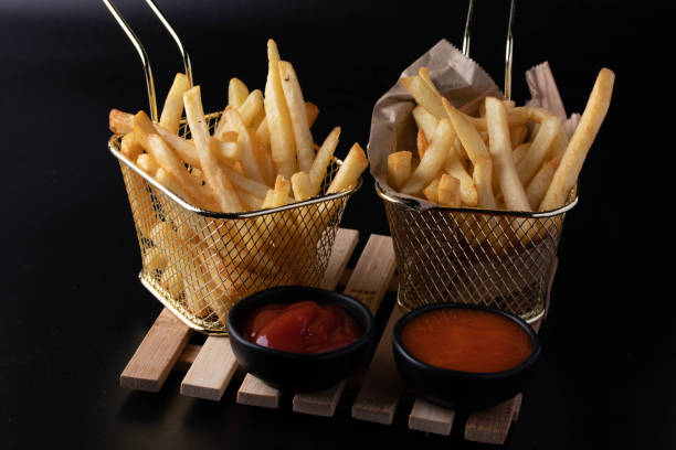 istock French fries in a basket on a black background 1398313125