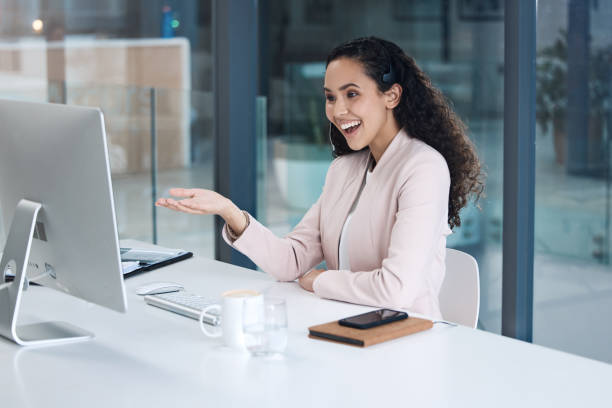 istock A smiling mixed race call centre agent looking happy and positive while wearing a headset. Female customer service worker using headset and consult with clients online while sitting at office desk 1398313370