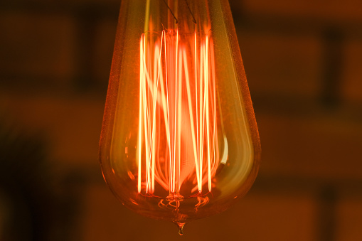 incandescent lamp on a dark background. filament spiral .