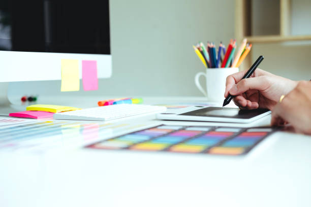 istock Two Graphic designer Brainstorming Meeting and drawing on graphics tablet at workplace 1398317447