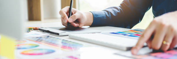 istock Two Graphic designer Brainstorming Meeting and drawing on graphics tablet at workplace 1398317472