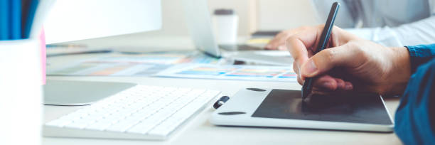 istock Two Graphic designer Brainstorming Meeting and drawing on graphics tablet at workplace 1398317488