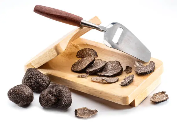 Photo of Black edible winter truffle on white background. The most famous of the truffles.
