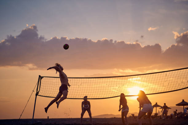 istock Friends playing volleyball on beach at sunset 1398322134