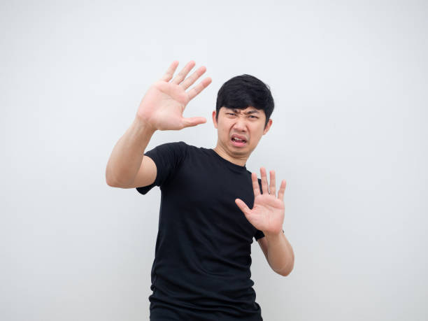 istock Man show hand close his face feeling afraid and shy 1398322283
