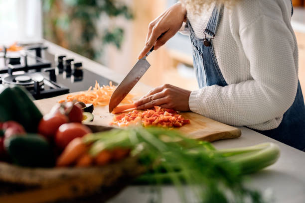 istock Woman preparing food in kitchen. 1398325870