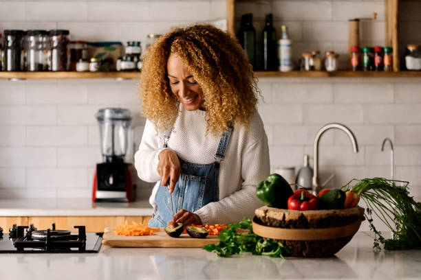 istock Woman preparing food in kitchen. 1398325873