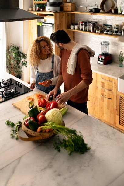 istock Couple preparing food in kitchen. 1398325879