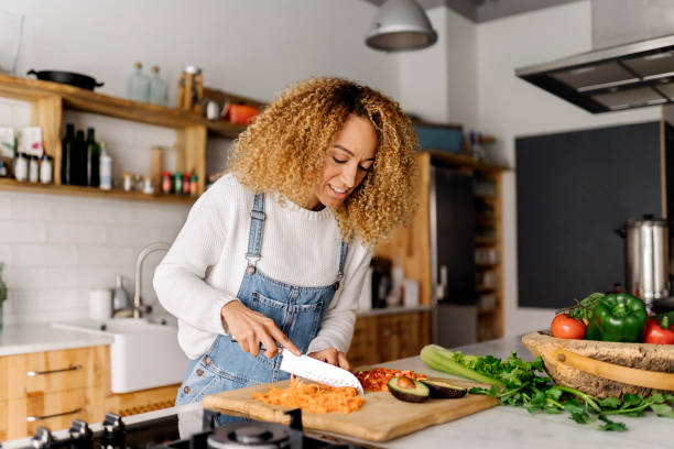 istock Woman preparing food in kitchen. 1398325884