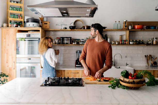 istock Couple preparing food in kitchen. 1398325891