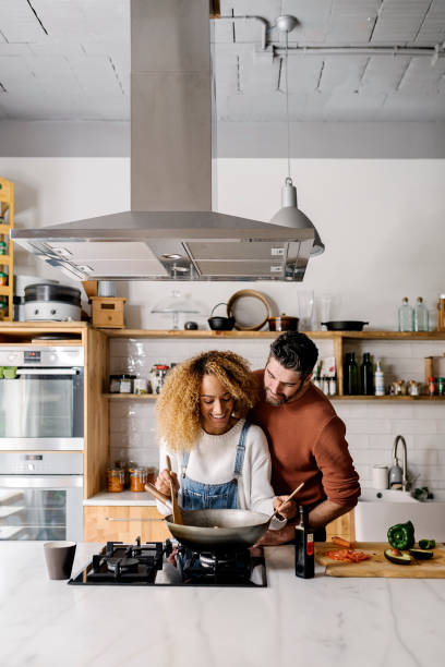 Couple preparing food in kitchen.