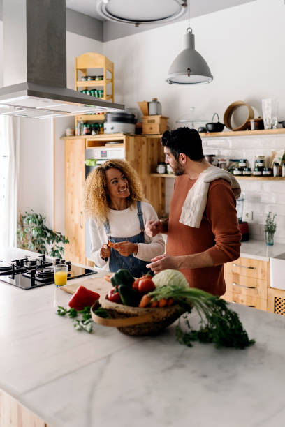 istock Couple preparing food in kitchen. 1398325913