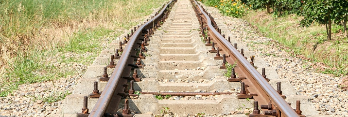 Close up of train track running through a field