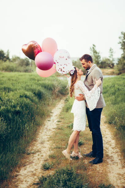 istock Bride and groom embracing each other by the river 1398327038