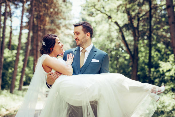 Groom carrying his bride on wedding day