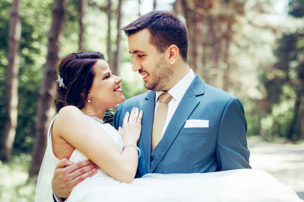 istock Groom carrying his bride on wedding day 1398327361