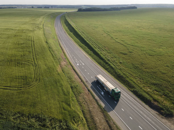 istock Aerial view on Highway road in the forest. View from a drone. Ca 1398329423