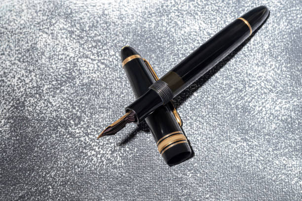 Fountain pen on a marble and gray background. Selective focus. copy space.