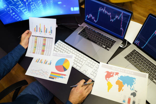 istock Businessman analyzing crypto currency market graphs on computer and laptop screen 1398330716