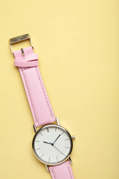 istock Pink wrist watches on beige background with copy space. 1398330851