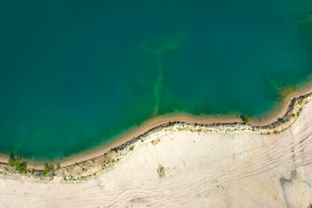 istock Gravel and sand open pit mining, pond with sediments - aerial view 1398330892