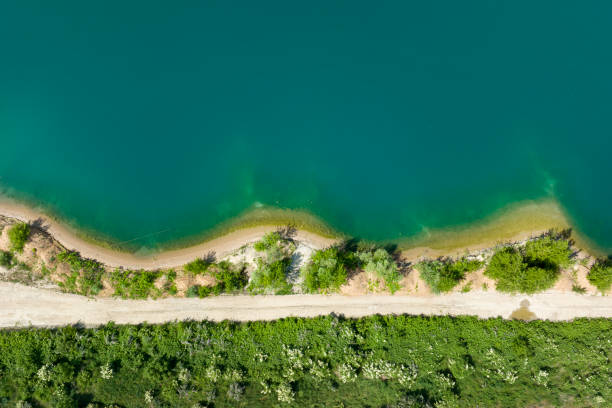 istock Gravel and sand open pit mining, pond with sediments - aerial view 1398330904