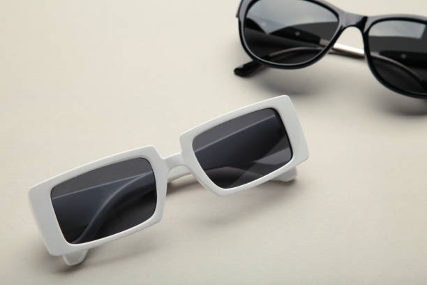 istock White and black sunglasses on grey background, top view, flat lay, minimalistic concept of summer, vacation 1398330970
