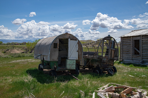 A covered wagon set up out on the prairie out west on the Oregon Trail.