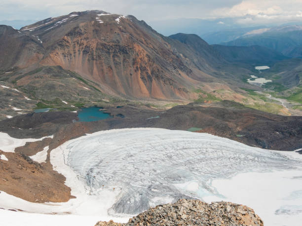 istock Bright mountain landscape with icefall at large glacier in sunlight. Awesome scenery with glacial tongue in sunshine. Amazing alpine view to snow mountain tops at very high altitude in sunny day. 1398336798